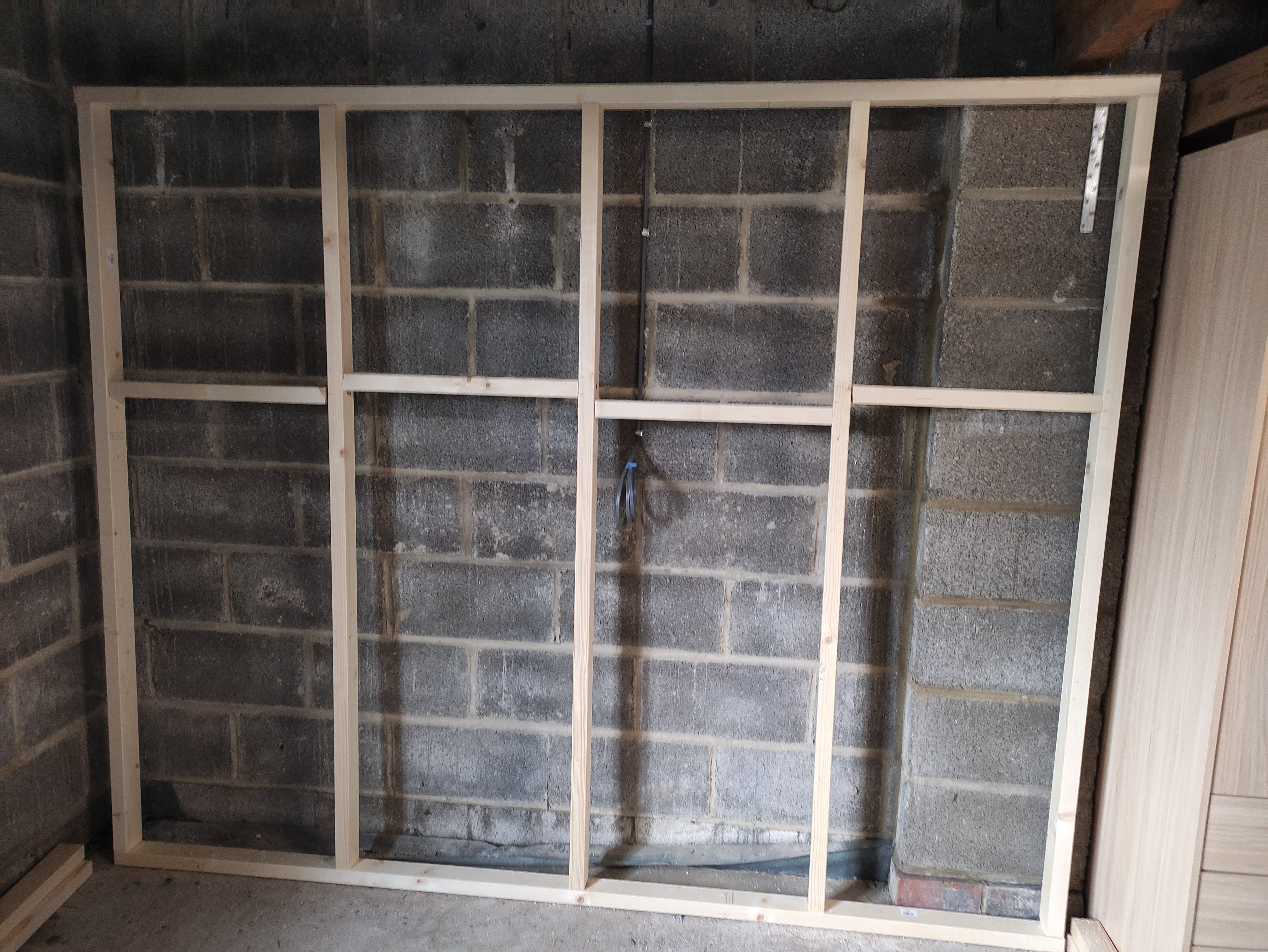 A wood frame with nogs at the top